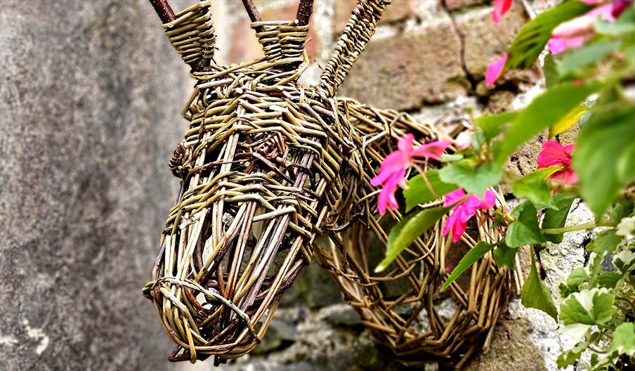 willow stags head mounted on a red brick wall