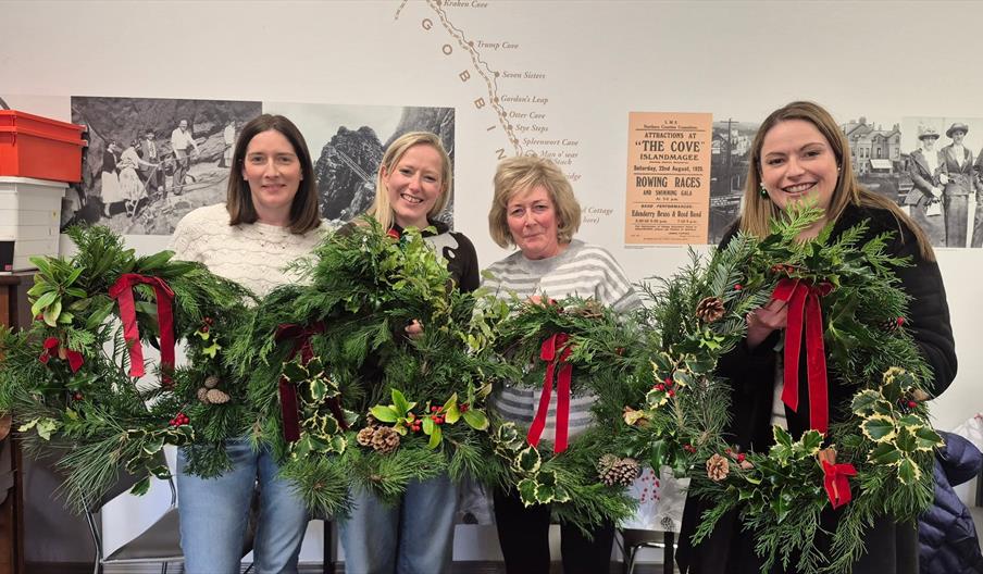 four ladies holding wreaths