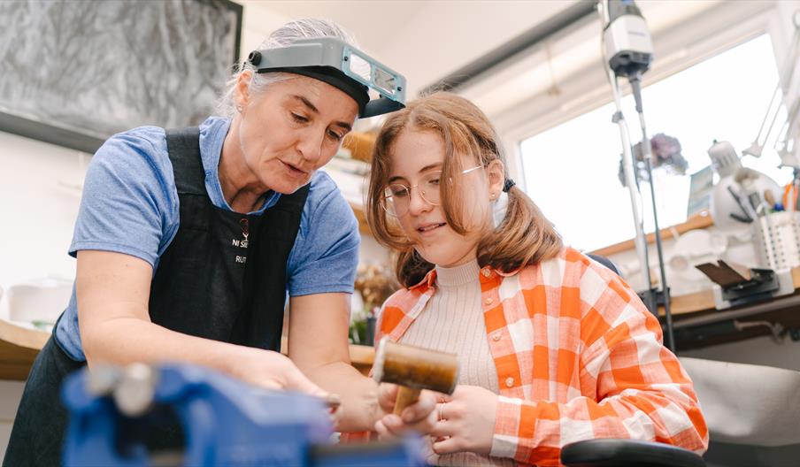Ruth from NI Silver instructing a young female student on a ring mandrel