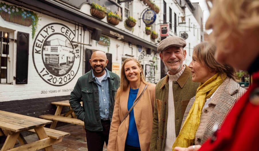 Group of friends on a walking tour outside Kelly's Cellars