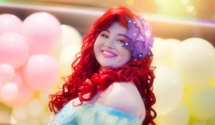 A female dressed as Ariel Princess