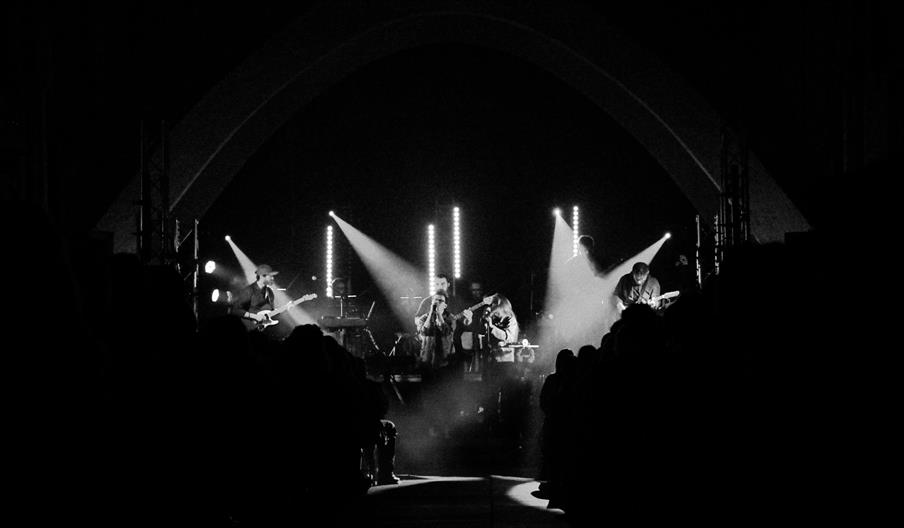 An Evening of Radiohead band performing on stage in a cathedral