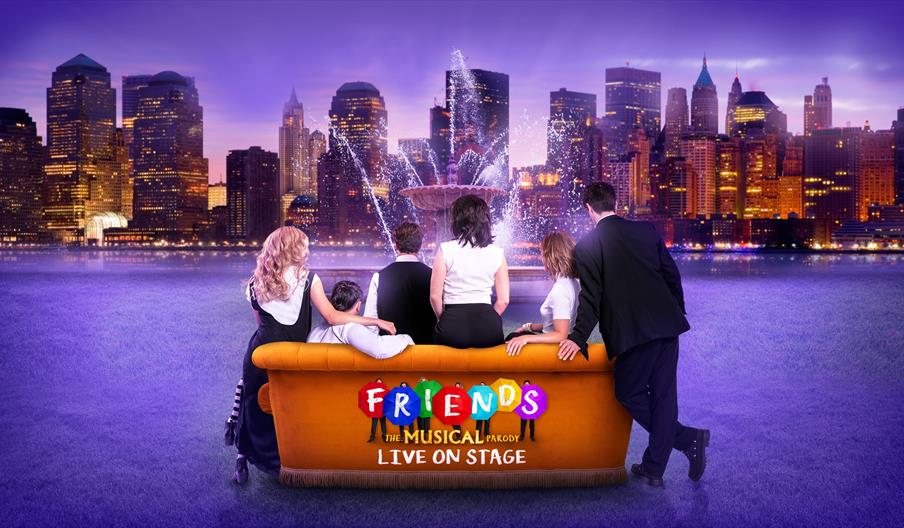 Six people sit on an orange couch facing a city skyline with a central fountain. The image text reads, "Friends: The Musical Parody, Live on Stage."