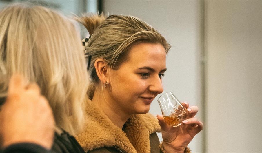 Customer sampling McConnell's Irish Whisky at the distillery.