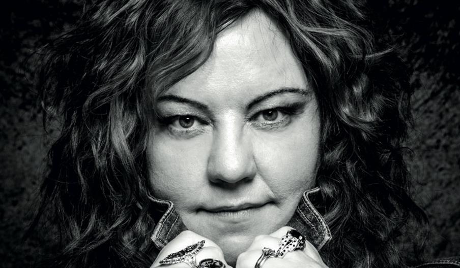 Black and white Close-up photography of Kaz Hawkins face holding her collar