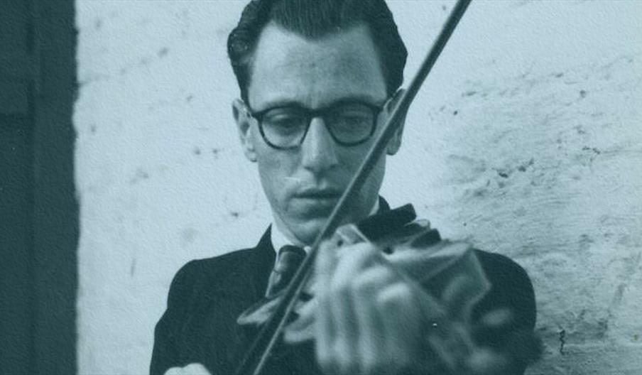 A black and white image of a man playing fiddle