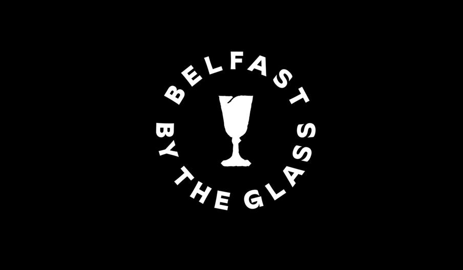 Logo with black background and white text saying Belfast By The Glass