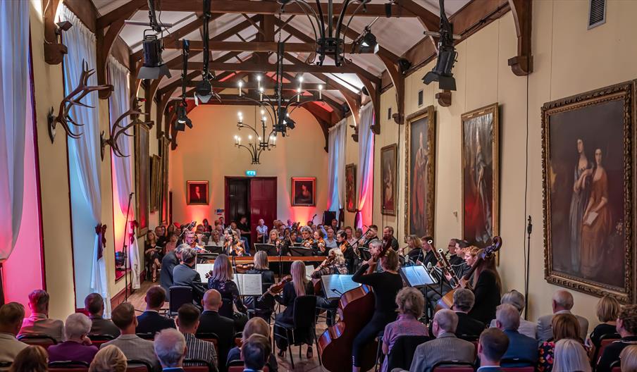 Orchestra playing in front of crowd