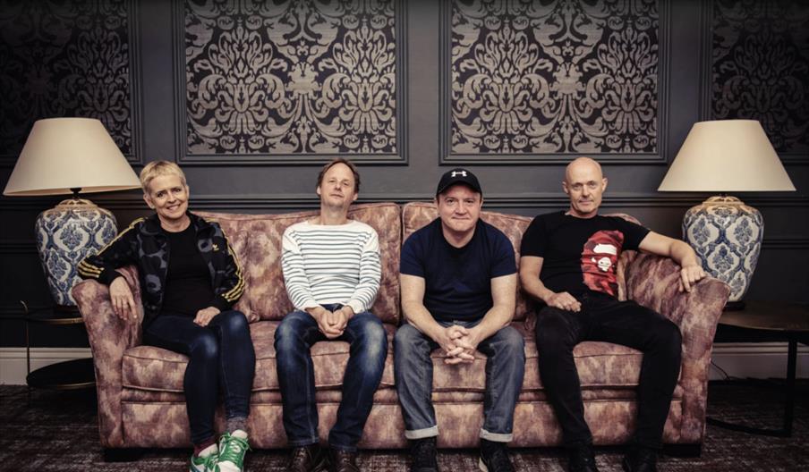 Four musicians from Flook sitting on a sofa