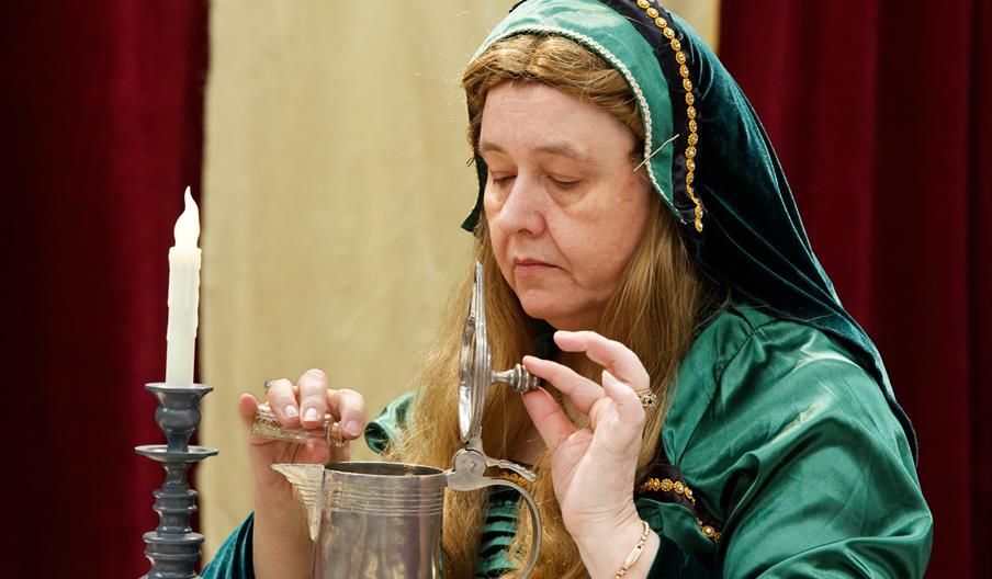 Image of lady putting poison in a cup