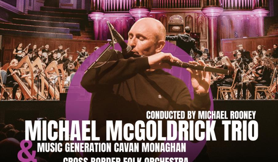 Michael McGoldrick playing flute at front of image and Cross Border Youth Folk Orchestra in the background