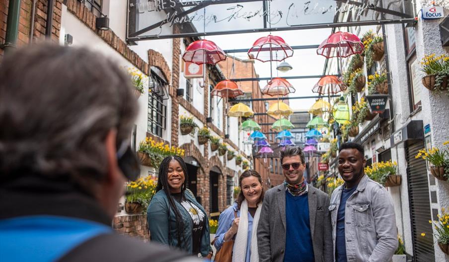 Tour guide with gorup of visitors outside City Hall