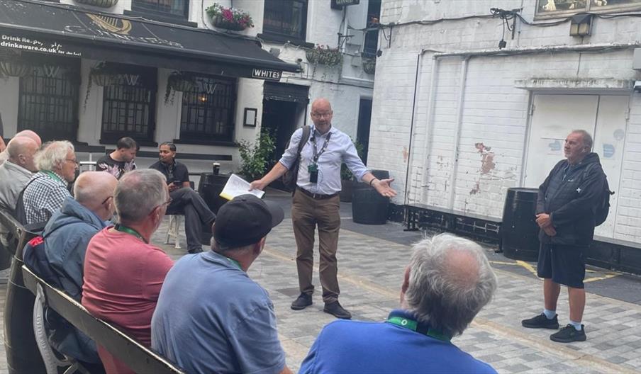 Picture of tour guide conducting the tour.
