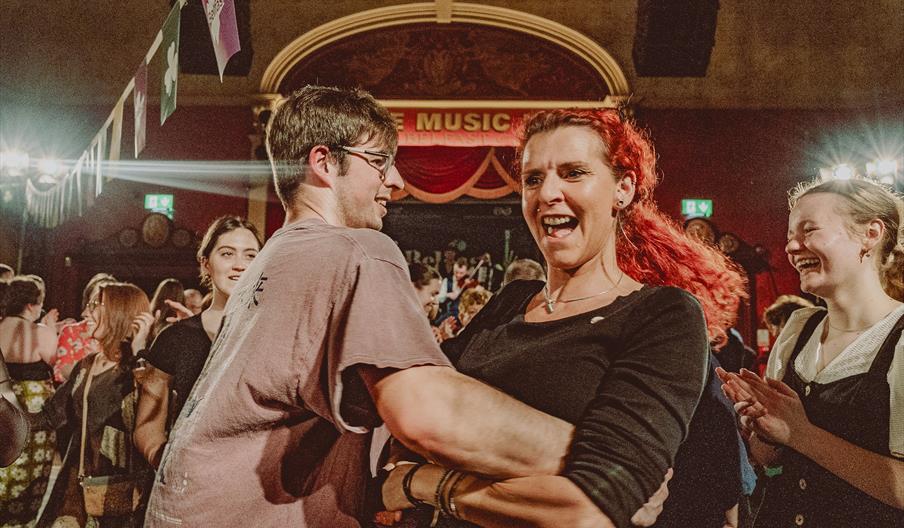 A pair dance in the crowd of the Sets Céilí Concert