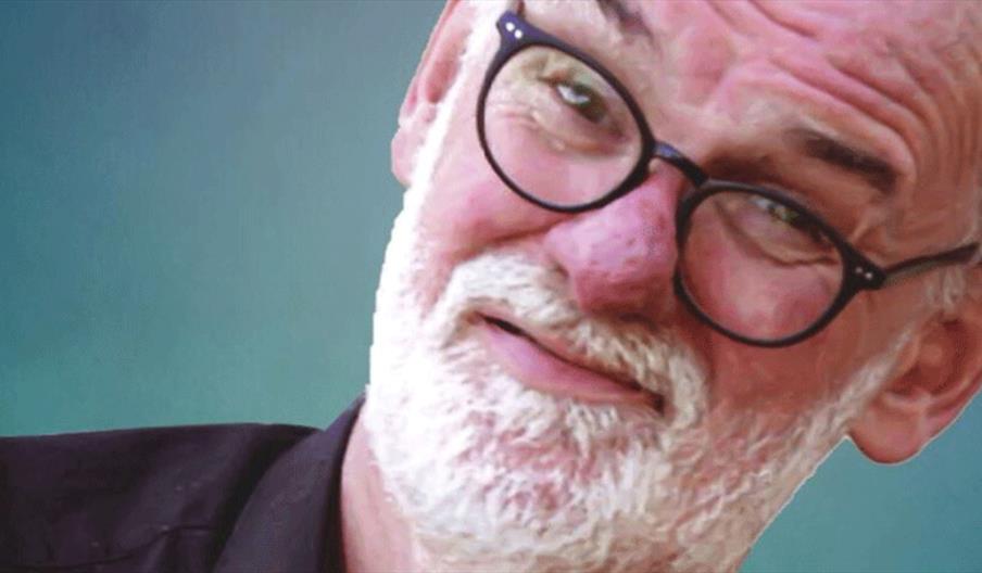 Photograph of Tim McGarry over a blue background.