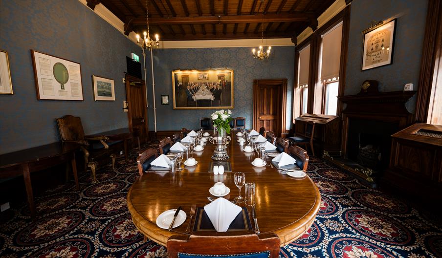 A group of camera journalists look on with concern as police officers wearing helmets and firearms vests point baton firearms past them