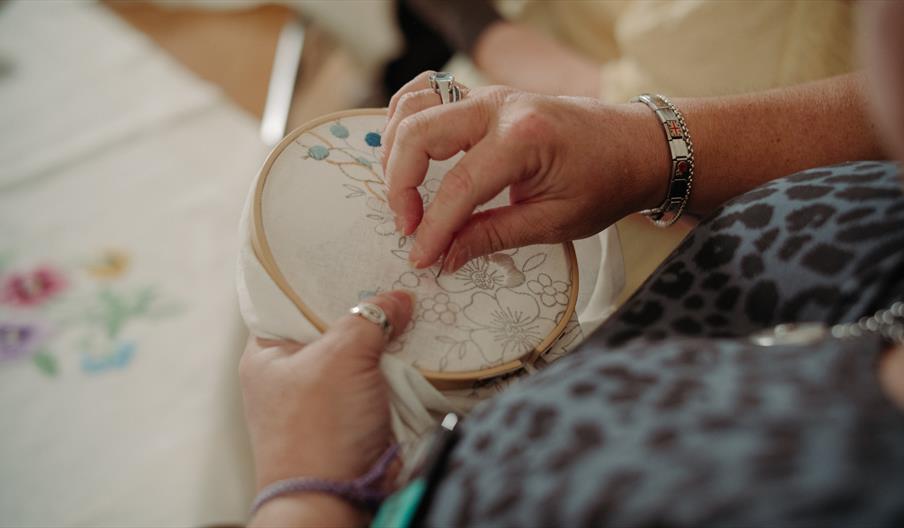 Female hands doing embroidery on a hoop
