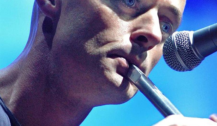 Brian playing whistle with mic in front of his face