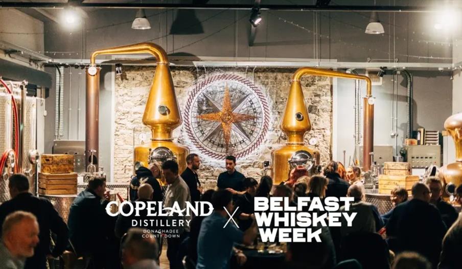 A distiller sharing whiskey with guests at Belfast Whiskey Week