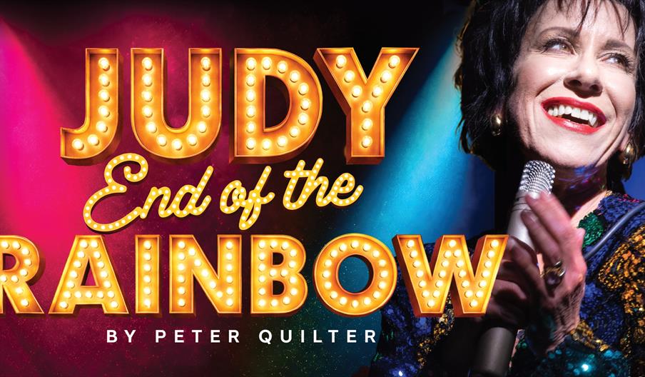 Promotional image for "Judy End of the Rainbow" by Peter Quilter, featuring a smiling woman holding a microphone against colourful lighting.