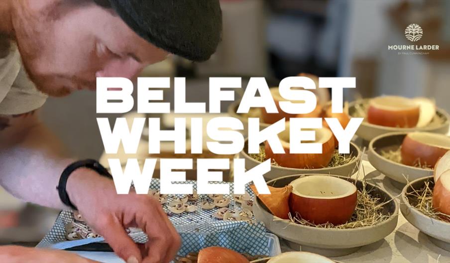 A chef presenting a course at a Belfast Whiskey Week dinner