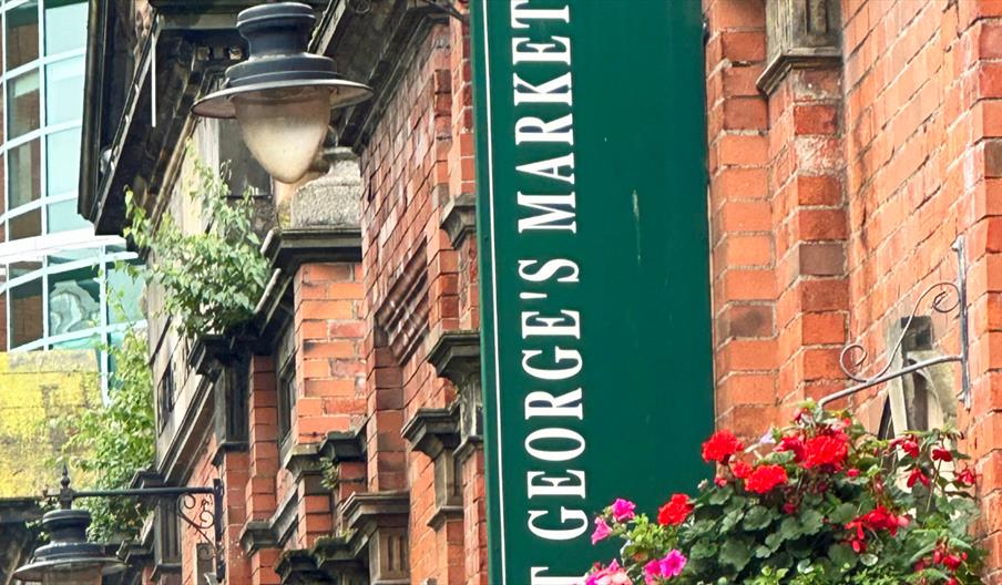 Image of St George's Market with signage and hanging baskets