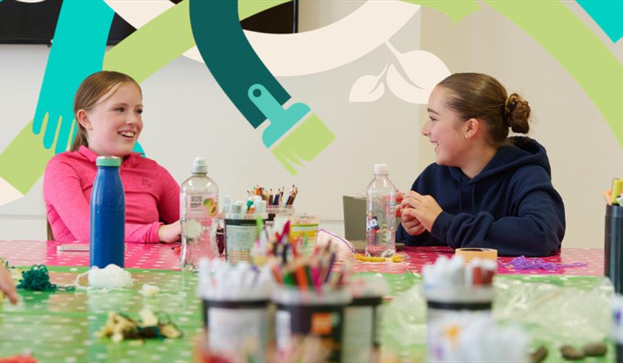 Two teens showing their art at the MAC arts school.