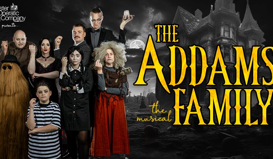 Cast of The Addams Family musical in costume, standing in front of a spooky mansion and graveyard background with show title.