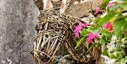 willow stags head mounted on a red brick wall