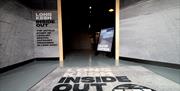 Entrance to exhibit with now open sign