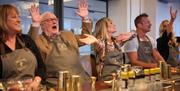 Group of people raising their hands and dancing in the Long Serve Bar.