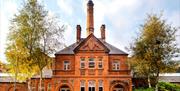 Picture shows red brick victoria bathouse with chimney