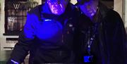 Image of two tour guides under blue light