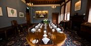 Edwardian Dining room with a long oval table with chairs set for lunch.
